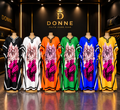 Donne floral print V-neck kaftan maxi dresses in black, white, orange, green, blue, and yellow on display mannequins.